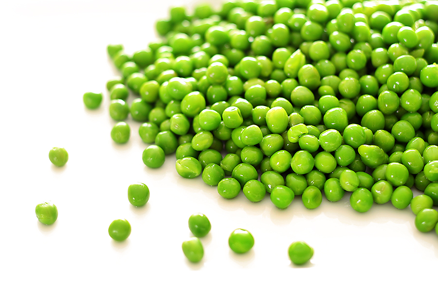 fresh spring peas isolated on white